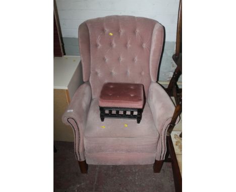 AN UPHOLSTERED ARMCHAIR TOGETHER WITH A STOOL