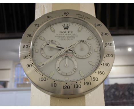 A modern aluminium wall clock in the form of a Rolex Oyster Perpetual Daytona