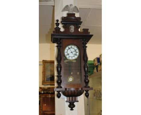 A Vienna style wall clock six inch white enamel dial, in case with eagle surmount and finials, (one detached but present) and