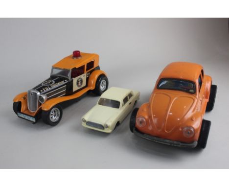 An Aoshin tinplate and battery operated model Volkswagen Beetle, a Taiyo FBI Godfather battery operated model car and a Flim 