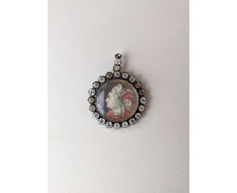 An 18th/19th century circular portrait miniature of a gentleman in profile wearing a turban with a feather, inscribed 'S A D 
