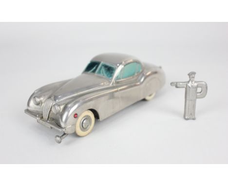 A Prameta Kolner Automodelle Jaguar XK 120 metal clockwork model car, in chrome, with key