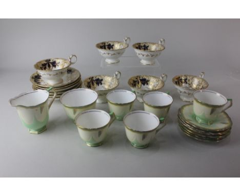 A set of six Victorian adelaide shape teacups and saucers gilt and blue foliate decoration and an Aynsley Art Deco set of fiv