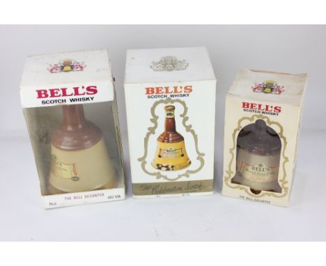 Two Bell's blended scotch whisky in Wade ceramic bell decanters, both 75cl and another smaller Bell's decanter, 37.5cl