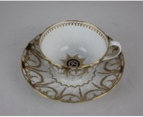 A Worcester fluted tea cup and saucer decorated with blue and gilt laurel swag border and star centre, blue crescent mark to 