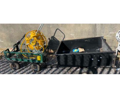 An Agricultural trailer together with another trailer and a hose pipe