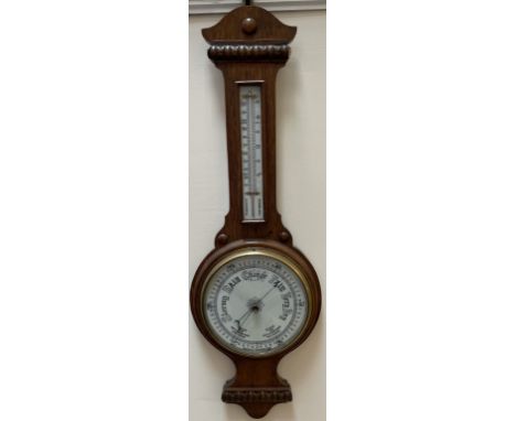An oak cased aneroid barometer with alcohol thermometer