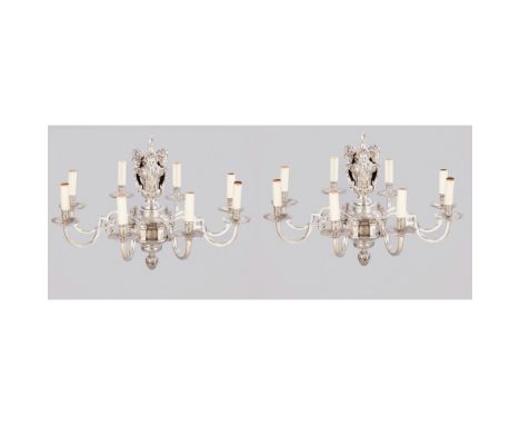 A Pair of eight-light chandeliersSilverplated metal Relief and chiseled decoration depictin foliage and caryatide motifs Euro