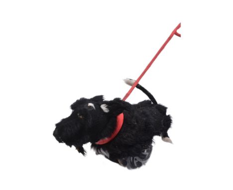 Forkbeard Fantasy - a 'lifesize' black dog street theatre puppet on wheels with a fixed rod lead. Wheels to base, with fur co
