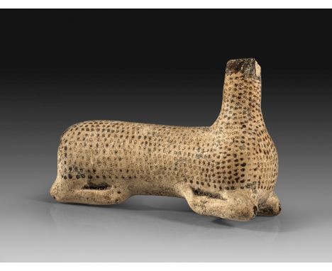Italo-korinthischer Aryballos in Form eines knienden Rehes. Frühes 6. Jh. v. Chr. L 9,5cm, H 6,8cm. Hellbrauner Ton mit dunke