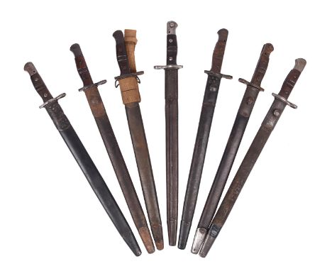 Seven United States model 1917 bayonets, by Remington, each with a steel mounted leather scabbard, one having a canvas frog. 