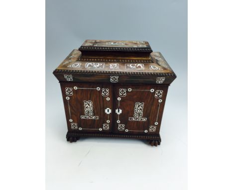 A Regency roseweod casket with Mother of Pearl inlay with various roundels and foliate decoration on card scallops supports c