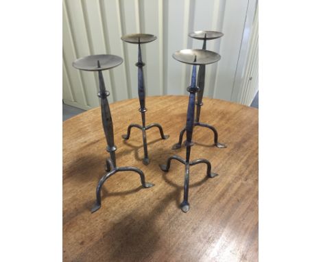 A collection of four Pugin style pricket stick candlesticks on tripod supports H38cm