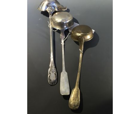 A German hallmarked silver C19th punch ladle with silver gilt bowl along with two further ladles. L34cm-36cm