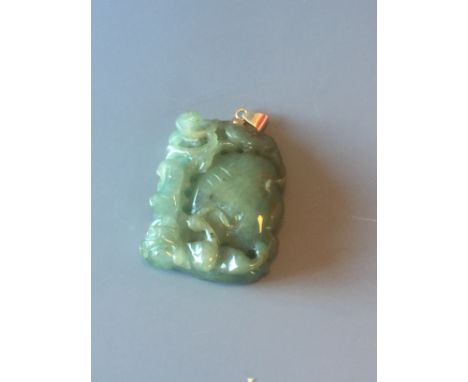 A green carved Jade Chinese pendant with mythological creature and foliate motif L5m W4cm