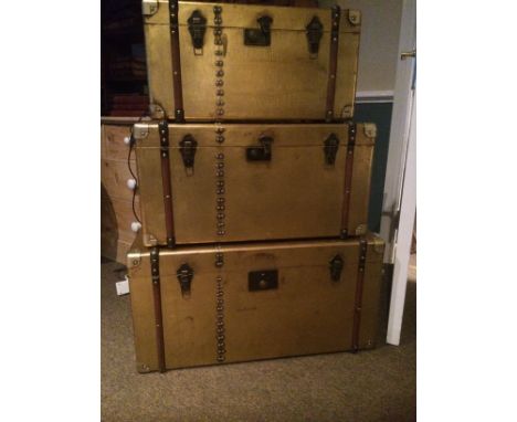 A graduated set of three gilt decorated "cabin trunk style" boxes largest H41cm W80 cm D41 cm
