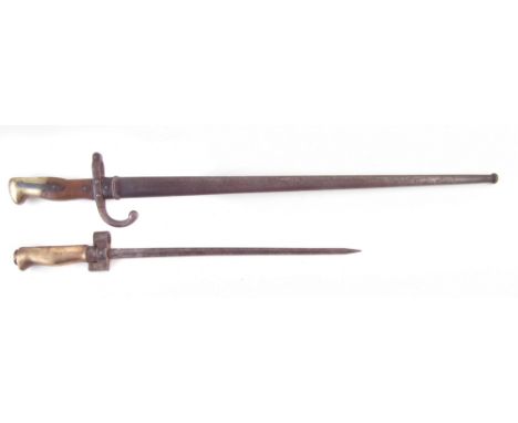 French model 1874 Gras bayonet and scabbard, the blade signed St Etienne, dated 1876, also a reduced Lebel rifle bayonet, the