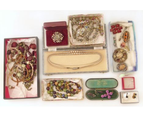 An assortment of mixed costume jewellery to include a pair of silver cufflinks, assorted costume brooches including one by Mi