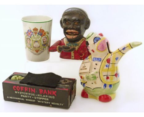 Tin plate wind-up "coffin bank" and cast iron Jolly Negro type money bank and ceramic "I Eat Pennies" money box etc Condition