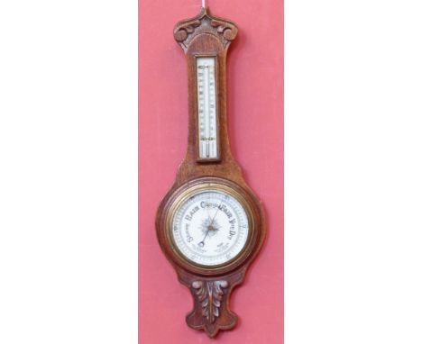 Edwardian oak aneroid barometer enclosing a thermometer Condition reports are not available for our Interiors Sales.