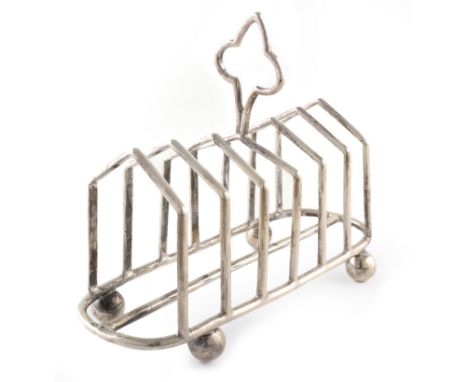 A silver toast rack by Mappin and Webb , plain polished body with six divisions on four ball feet, stylized gothic style hand