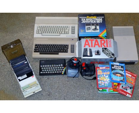 A COLLECTION OF VARIOUS VINTAGE/RETRO COMPUTER SYSTEMS INCLUDING AN ATARI 2600, A SINCLAIR ZX SPECTRUM, COMMODORE 64 ETC WITH