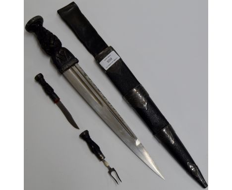 AN OLD LEATHER BOUND SCOTTISH DIRK WITH CELTIC MOTIFS & REMOVEABLE KNIFE & FORK     