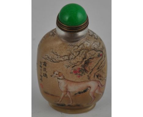 A Chinese reverse painted snuff bottle painted with scenes of hunting hounds