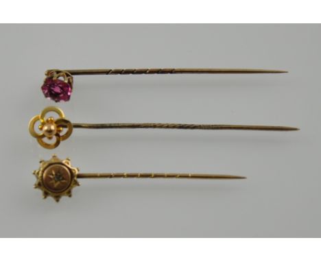 Three late Victorian yellow gold stick pins, two set with pink tourmaline and diamond