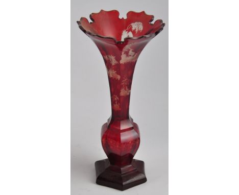 A 19th Century Bohemian ruby overlaid flash engraved glass vase of hexagonal trumpet form decorated with stags in woodland la