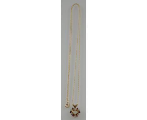 A 9ct gold ruby and diamond heart pendant on a 9ct chain