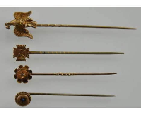 Four Victorian and later yellow gold and yellow metal stick pins, one with a hinged Eagle terminal 