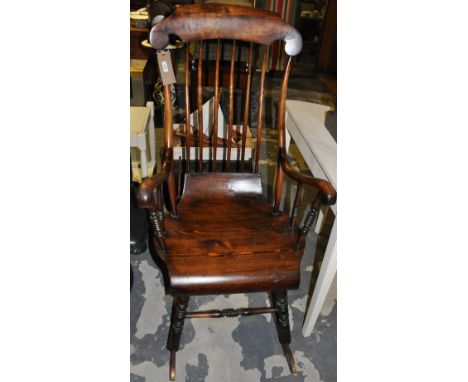 A late 19th/early 20th Century Swedish pine fruitwood comb back rocking chair with downswept arms on six turned legs