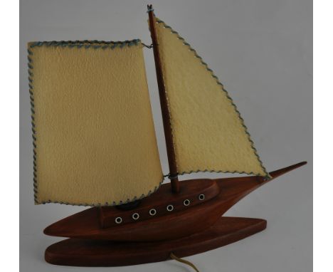A 1950s wood and vinyl table lamp in the form of a sailing yacht, H. 37.5cm