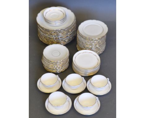 An extensive Continental white bone china dinner service, the scalloped rims with gilt bands, comprising seven dinner plates,