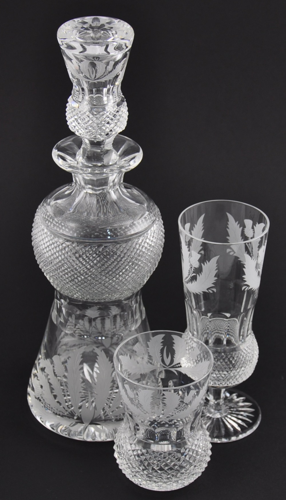 An Edinburgh crystal thistle shaped cut glass whiskey decanter, the