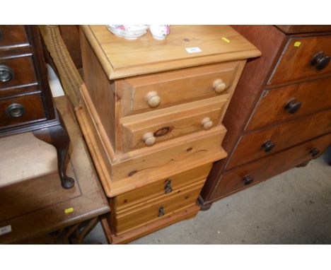 Two pine two drawer bedside chests and a white painted stick back chair