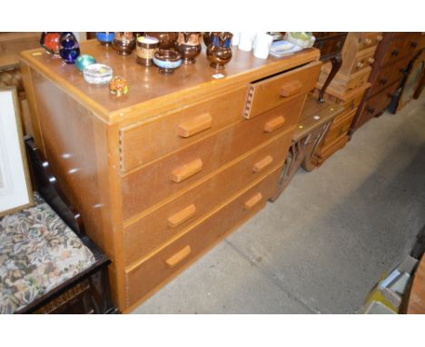 A light oak chest fitted two short over three long drawers