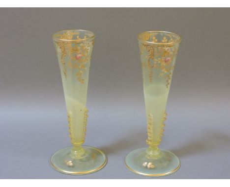 A pair of late Victorian glass specimen vases, each decorated in enamel with spring flowers and highlighted in gilt, 16.5cm h