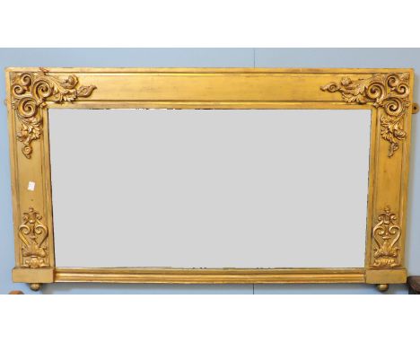 A Victorian oval gilt framed wall mirror, and a rectangular overmantel mirror