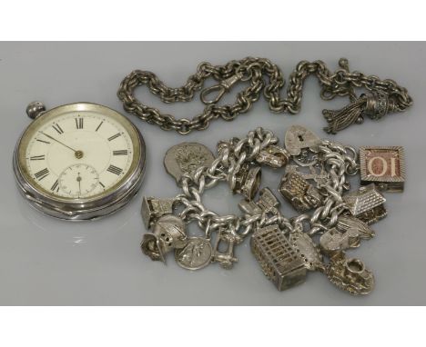 A silver charm bracelet, with silver and white metal charms including a telephone box, and an open faced pocket watch, with e