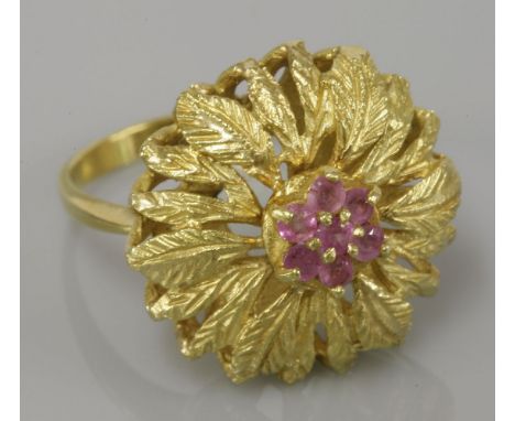 A ruby cluster ring, with foliate surround stamped 750