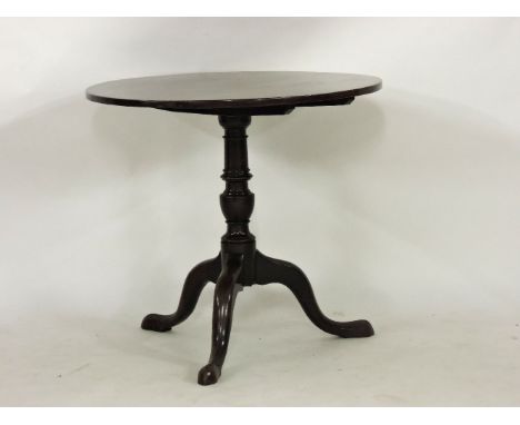 A George III mahogany tilt top tripod table, with turned baluster support, 78cm diameter