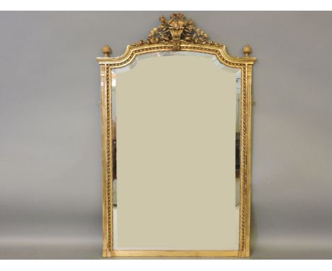 A large gilt framed pier mirror, with a crest of musical motifs over bevelled plaster, 102cm wide, 159cm high