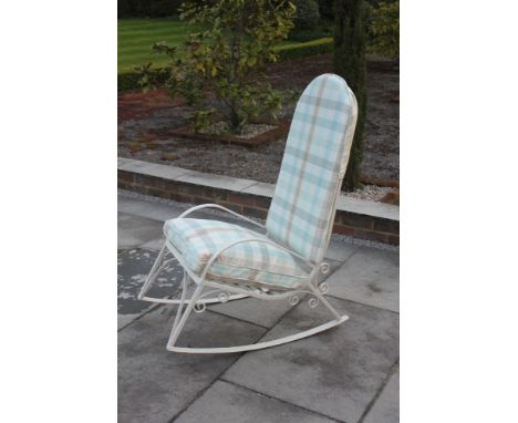A white painted iron strut work garden rocker, with scrolling bracket support