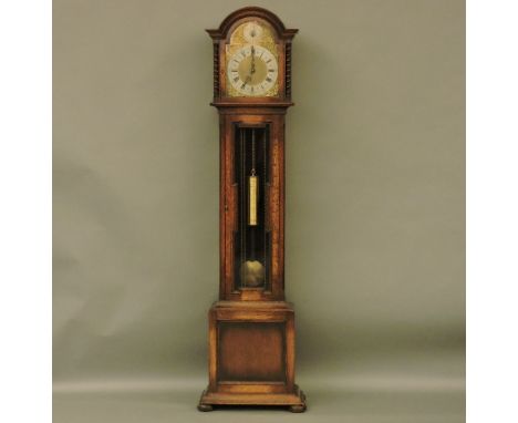A mid 20th century Winterhalder & Hofmeier oak case long cased clock, the three train movement striking the quarter hours, an