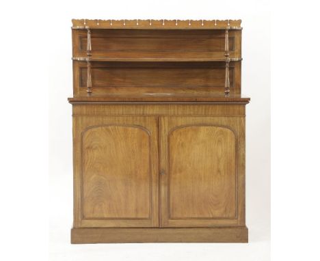 An early Victorian mahogany chiffonier, with a two shelf back, over a panelled cupboard, 115cm wide, 36cm deep, 144cm high