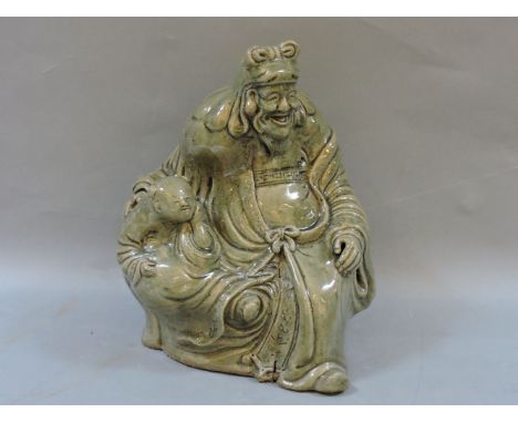 A celadon ceramic group, of an old man and a small boy