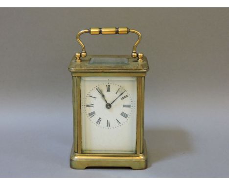 A carriage clock, with black Roman numerals in corniche case