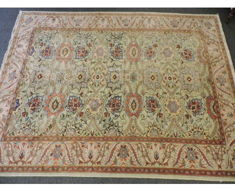 A large pale green ground Oriental carpet, with scrolling foliate field, 343 x 260cm, and a small pink ground rug